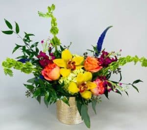 Bells of Ireland, Yellow cymbid blooms, lavender stock, free spirit roses, veronica and seeded euc in a rounded rectangle - a wonderful mix of our favorite flowers!