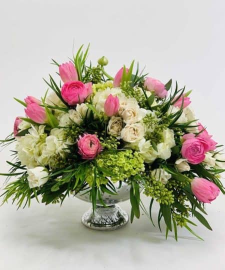 An Elegant classic of pink tulips and rununculus, white roses, hydrangea and seeded eucalyptus finished in a silver bowl.